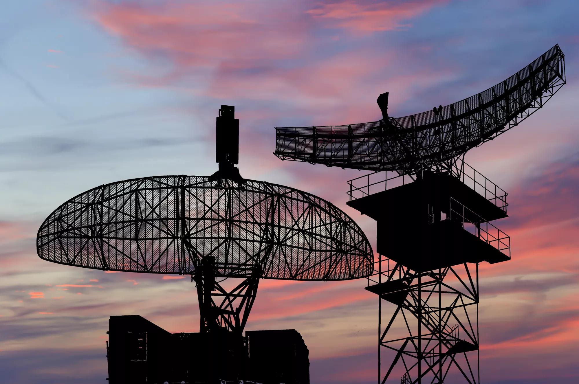 Air defense radars of military mobile anti aircraft systems, modern army industry on the background of the sunset orange sky, Russia