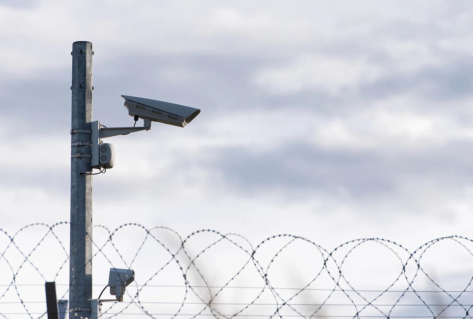 Surveillance Camera and barbed wire, border, prison, concept picture