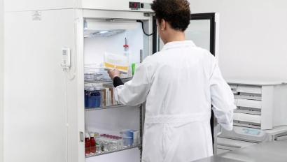 Retrieving vaccine from refrigerator monitored by Securitas Healthcare T15 tag