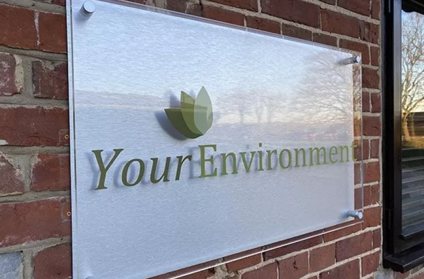 Your Environment sign on brick wall.