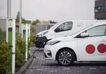 Securitas and Securitas Technology electric vehicles in a parking lot connected to a vehicle charging point