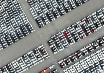 aerial top down view of a parking lot new cars lined up in the port for import and export international.