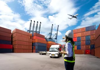 Foreman Woman control loading Containers box from Cargo freight ship for import export.