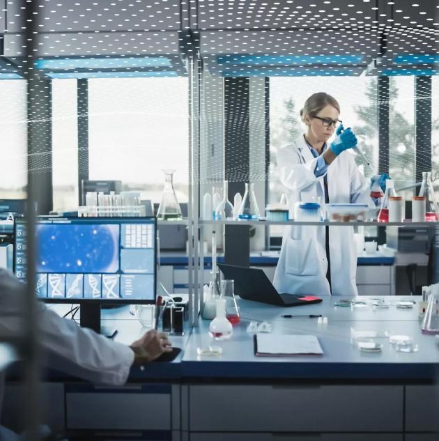 Female Medical Scientist Wearing White Coat and Safety Glasses uses Micropipette while Examining Testing Sample. Innovative, Experimental Drugs Research, Biotech Development in High-Tech Laboratory