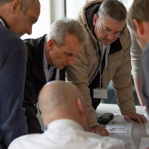 A confident team leader providing instructions to a group of emergency preparedness team members.