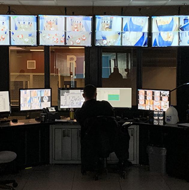 Prison guard monitoring corrections security station